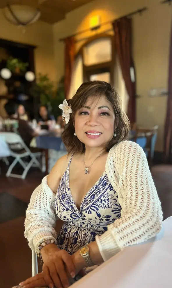 Portrait of Dr. Rossana T. Alfonso smiling in a warm indoor setting, representing a friendly and experienced dentist at Mira Mesa Dental - Mira Mesa Dental