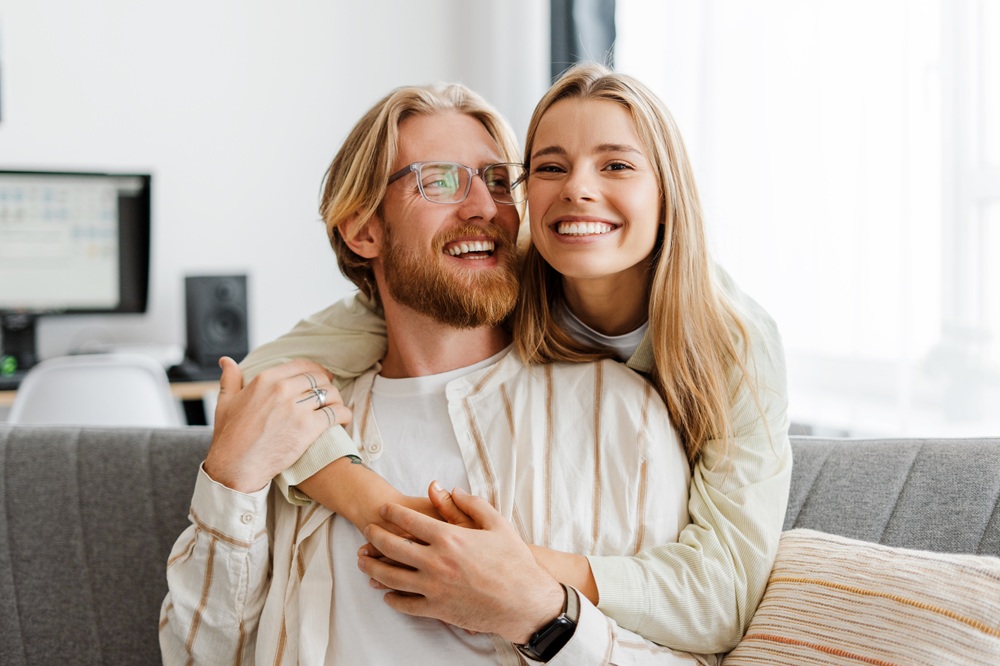 Smiling couple embracing indoors with bright, healthy smiles, representing comfort and quality care at Mira Mesa Family Dentistry - Mira Mesa Family Dentistry